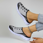 a pair of black lightweight footwear on a plain background