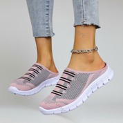 a pair of pink lightweight footwear on a plain background