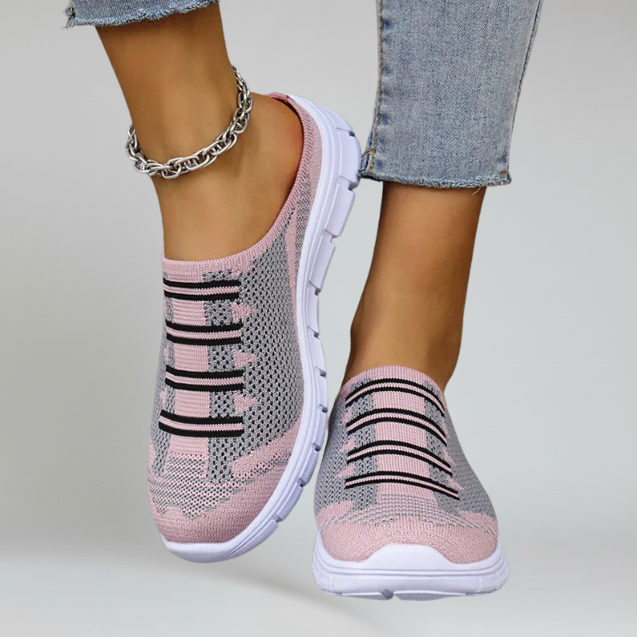 a pair of pink lightweight footwear on a plain background