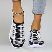 a pair of black lightweight footwear on a plain background