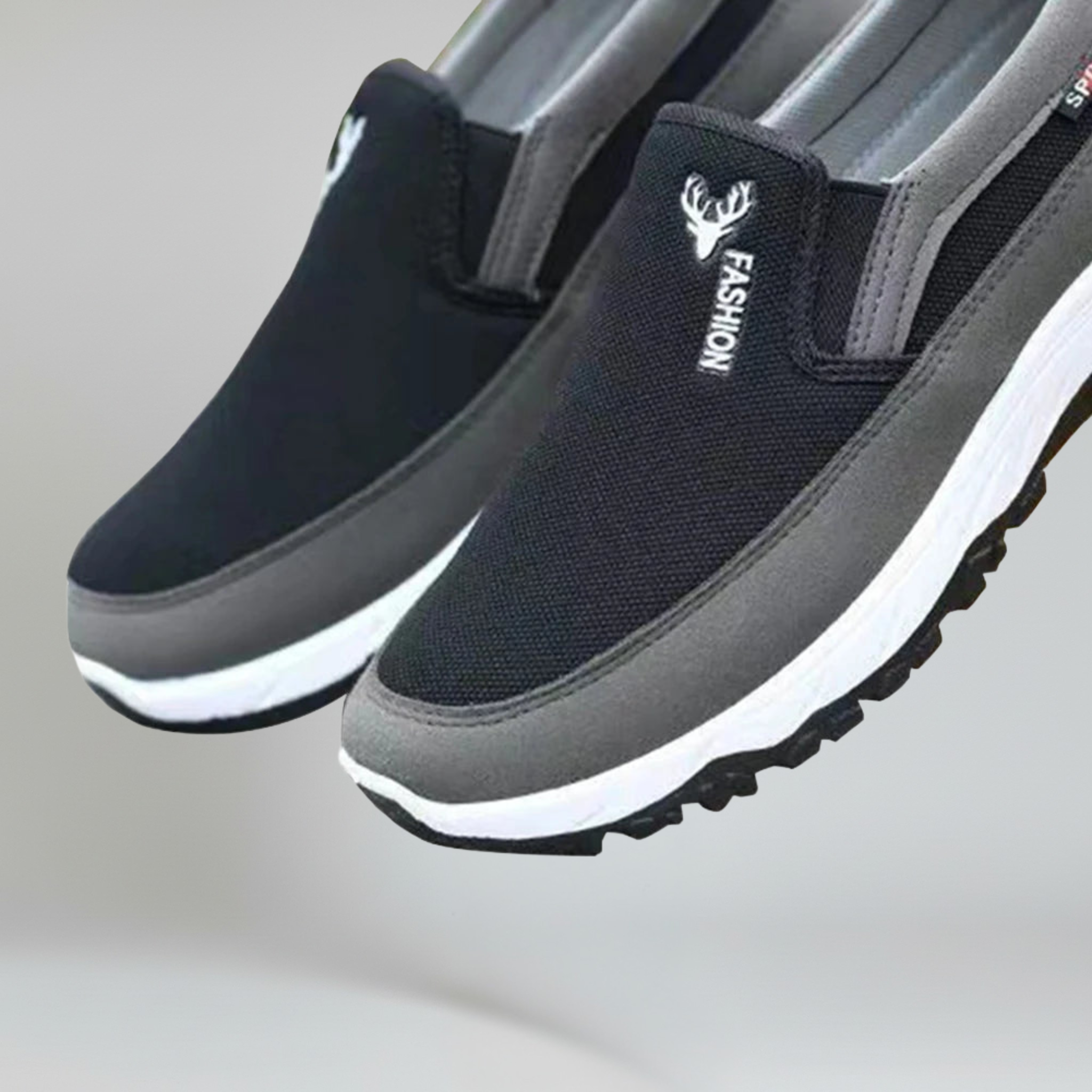 a pair of black boat shoes for men on a plain background