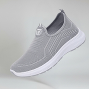 Gray slip-on sneaker with white sole on a light gray background