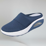 dark blue wedge slipper on a plain background