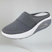 grey wedge slipper on a plain background