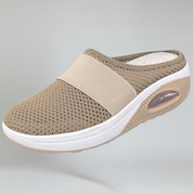 beige wedge slipper on a plain background