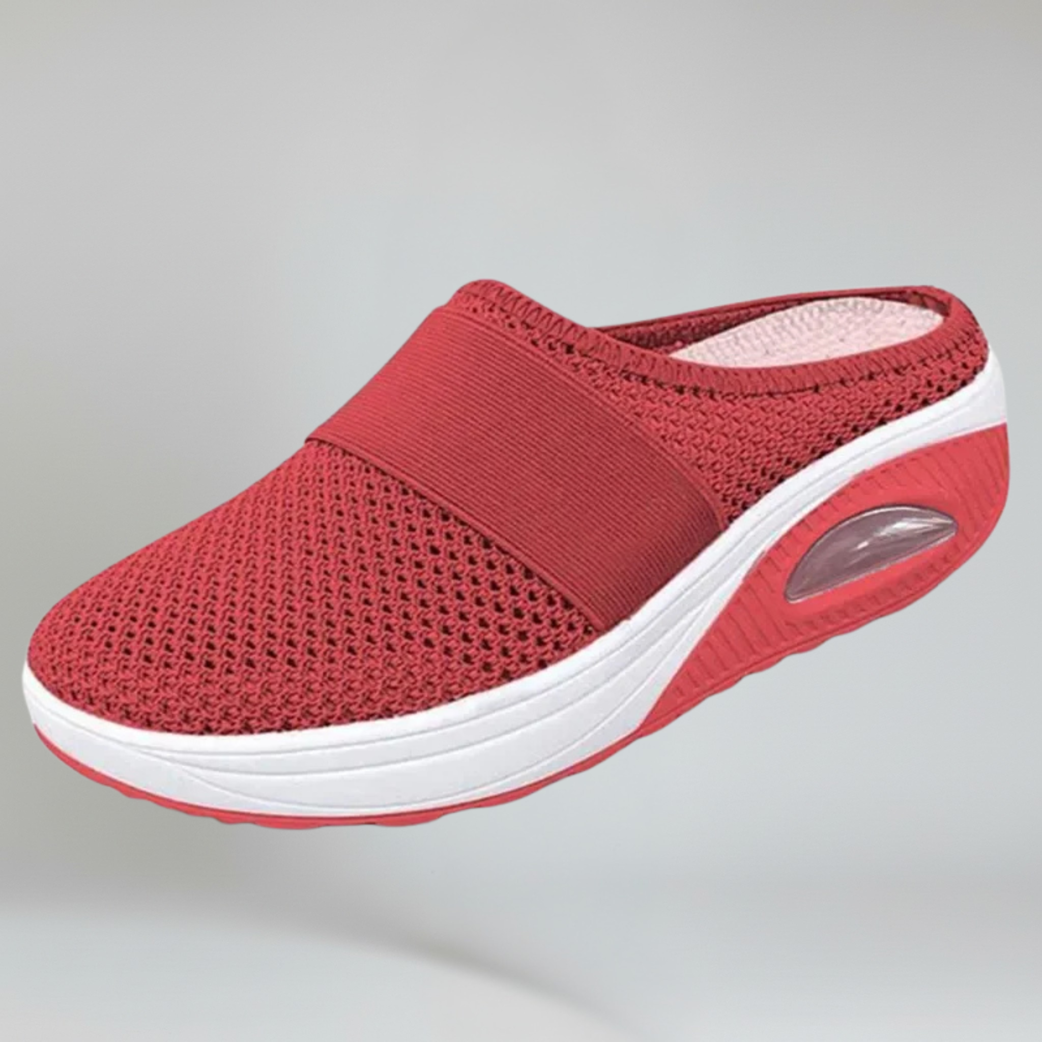 red wedge slipper on a plain background