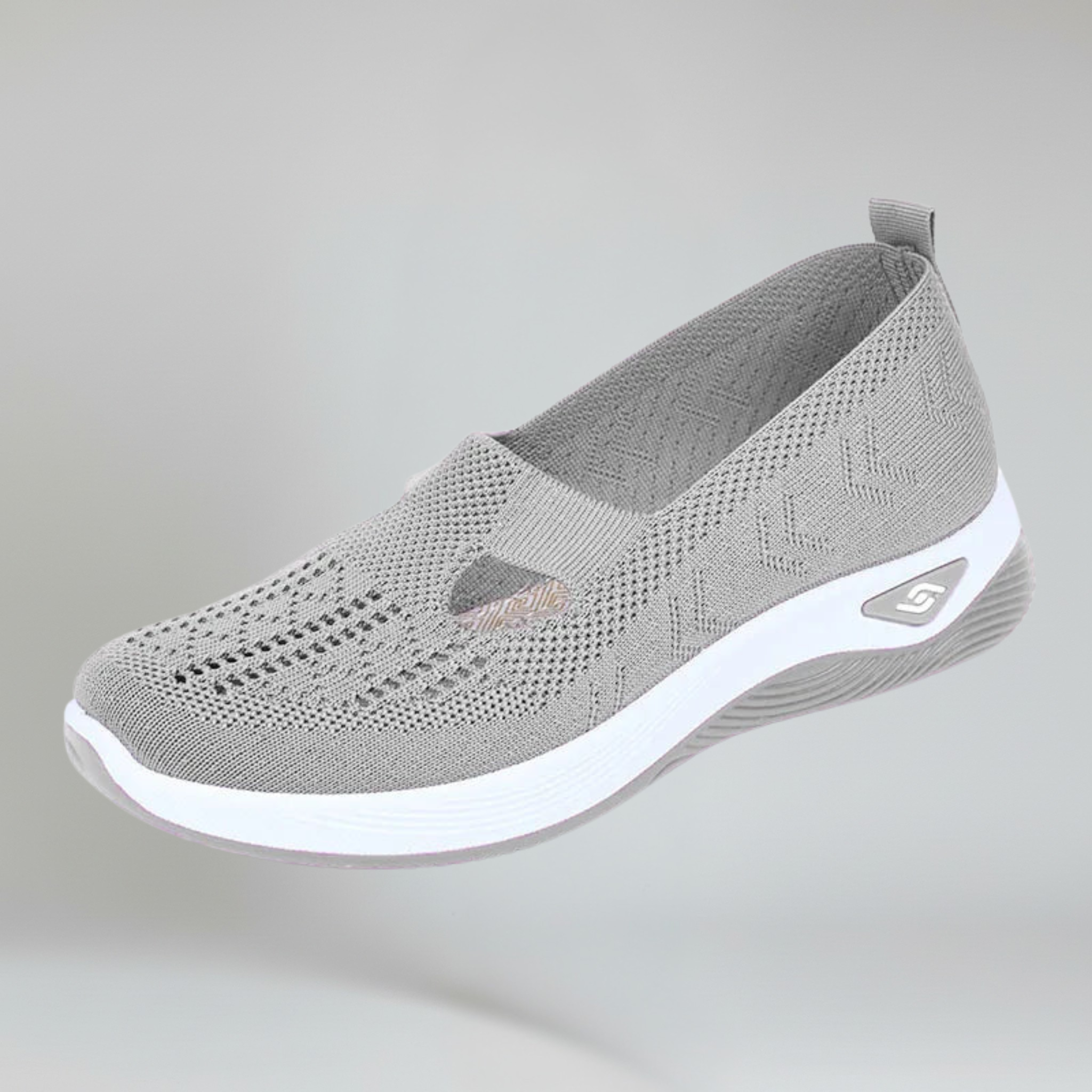 women's grey slip-on sneakers on a plain background