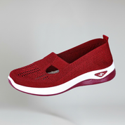red slip-on sneakers for women on a plain background