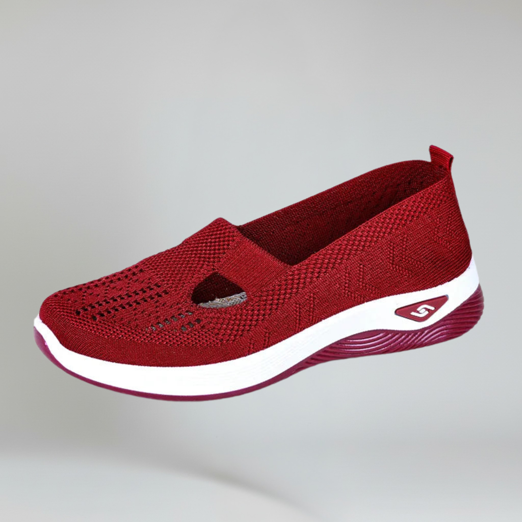 red slip-on sneakers for women on a plain background