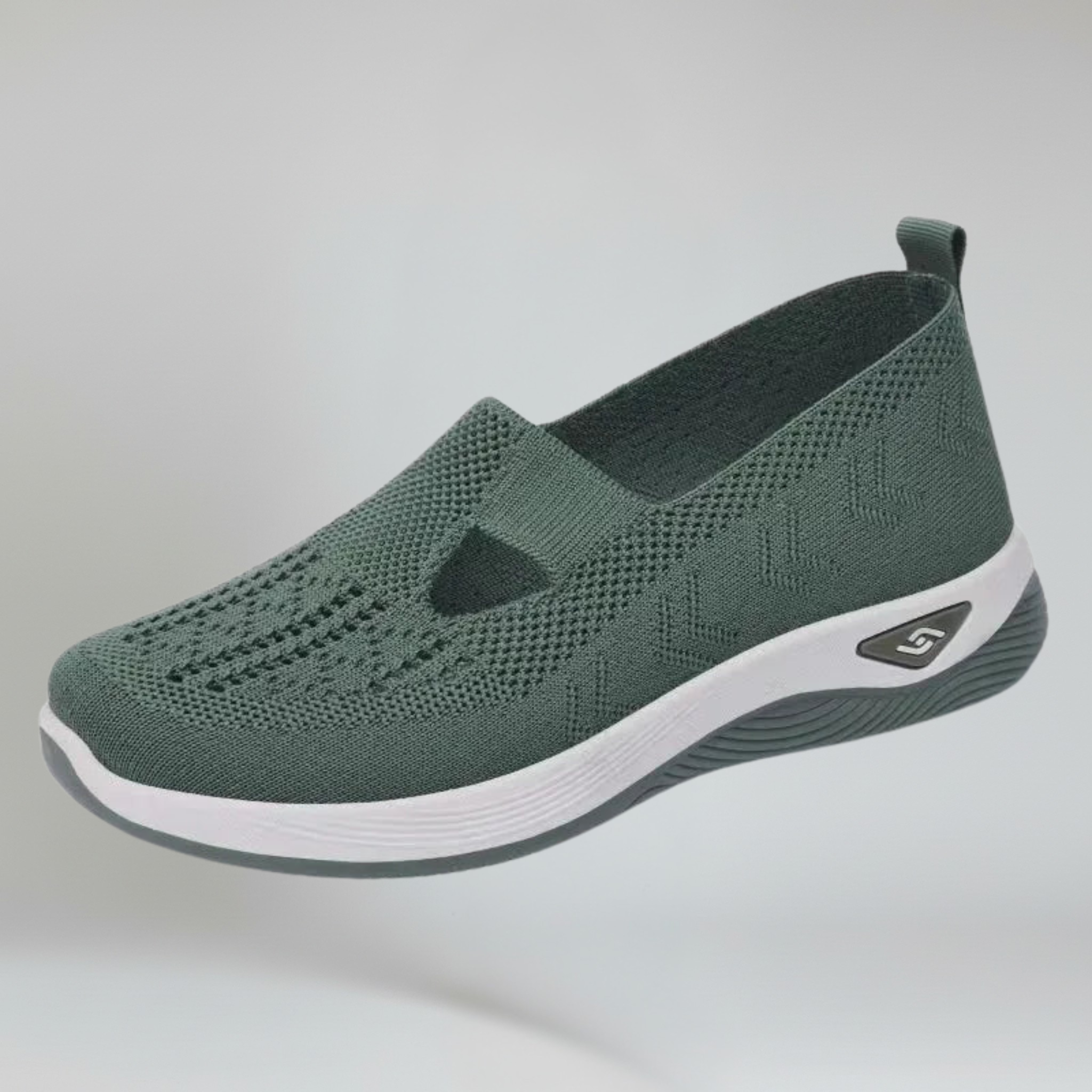 women's green slip-on sneakers on a plain background 
