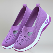 a pair of women's purple slip-on sneakers on a plain background