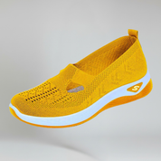yellow slip-on sneakers for women on a plain background
