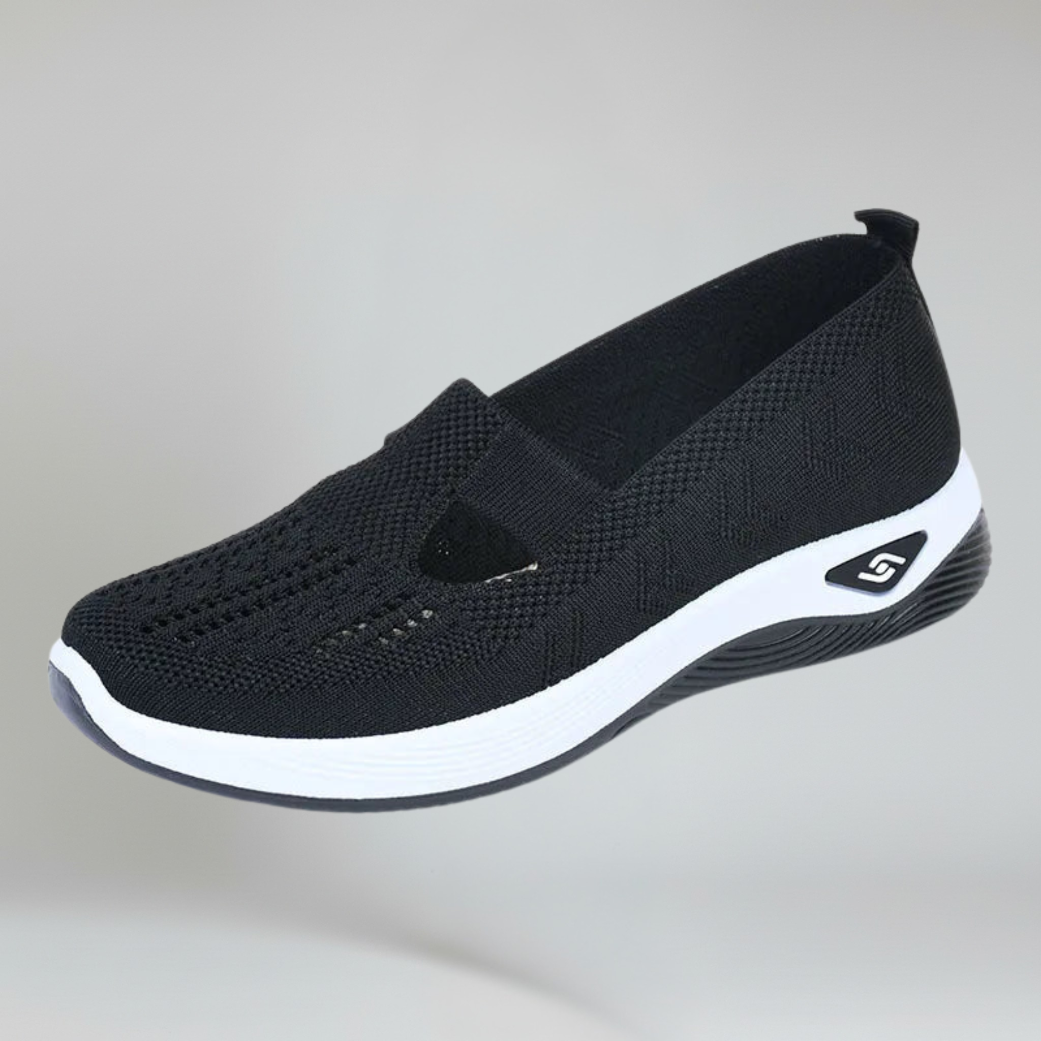 women's black slip-on sneakers on a plain background