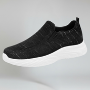 black walking shoes on a plain background